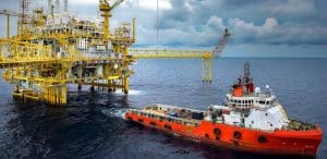towboat in front of oil rig